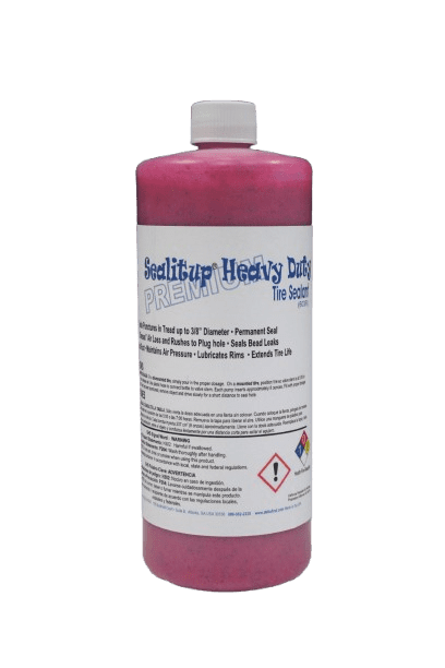 Pink tire sealant bottle on black background